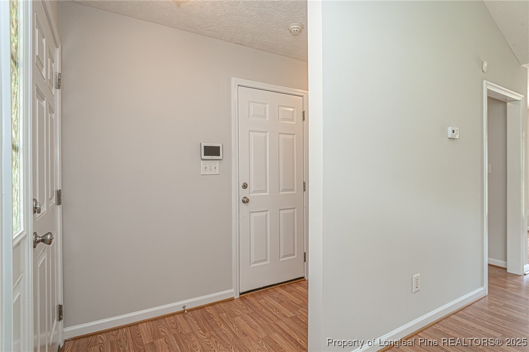 7650 Rufus Johnson Road Fayetteville, NC 28306 - Photo 3 of 43 a view of a hallway with wooden floor