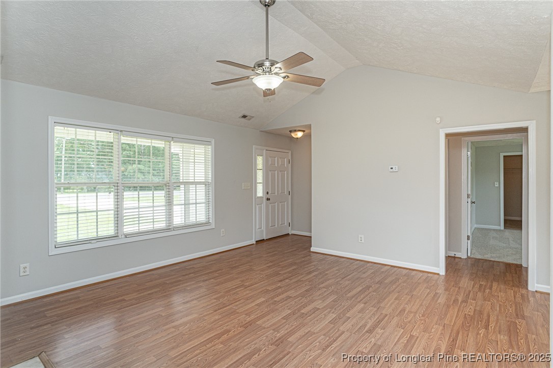 7650 Rufus Johnson Road Fayetteville, NC 28306 - Photo 5 of 43 a view of an empty room with wooden floor and a window