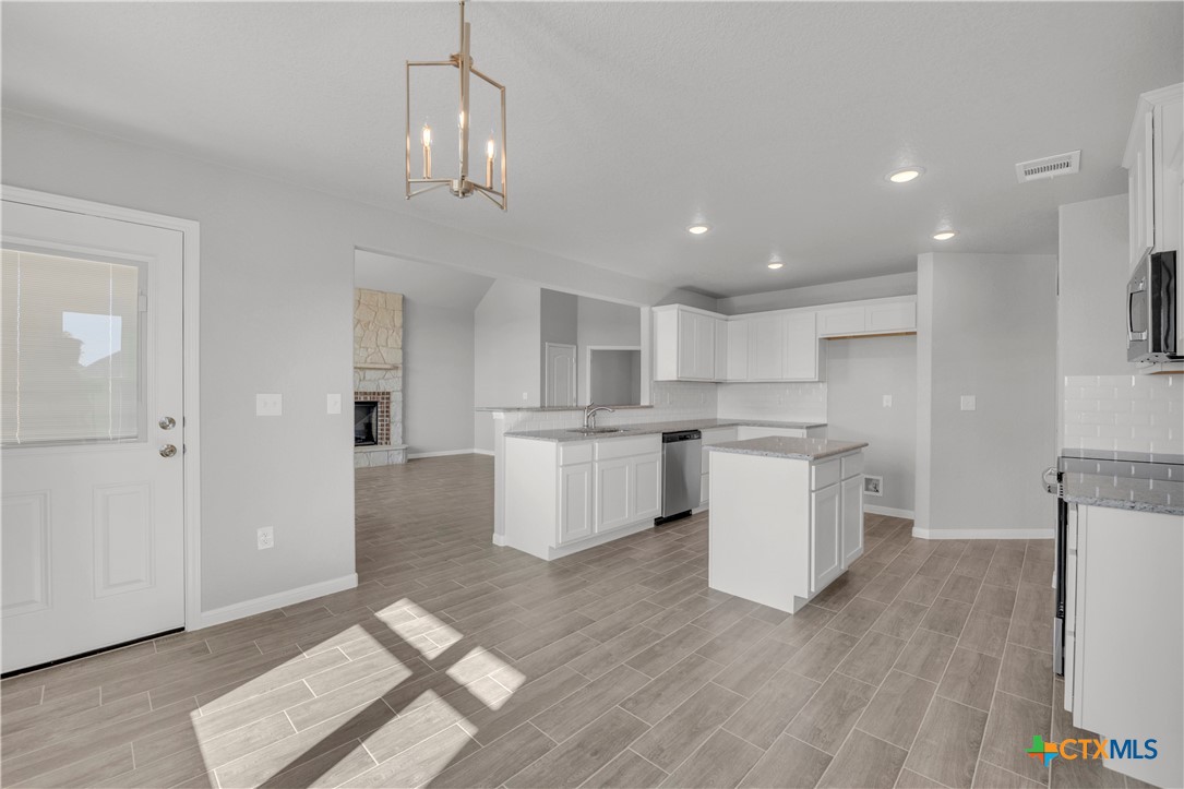 215 Overlook Trail Copperas Cove, TX 76522 - Photo 13 of 36 a kitchen with a refrigerator and a sink