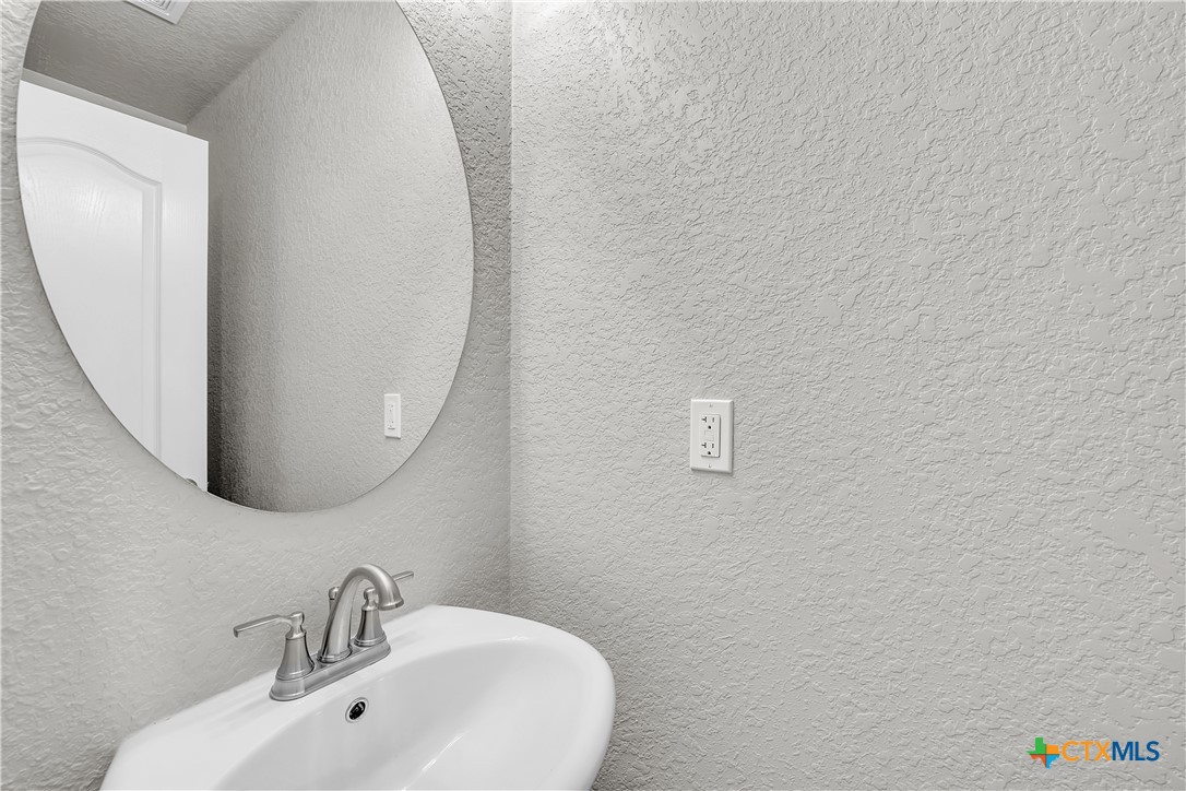 215 Overlook Trail Copperas Cove, TX 76522 - Photo 19 of 36 a bathroom with a sink and a mirror