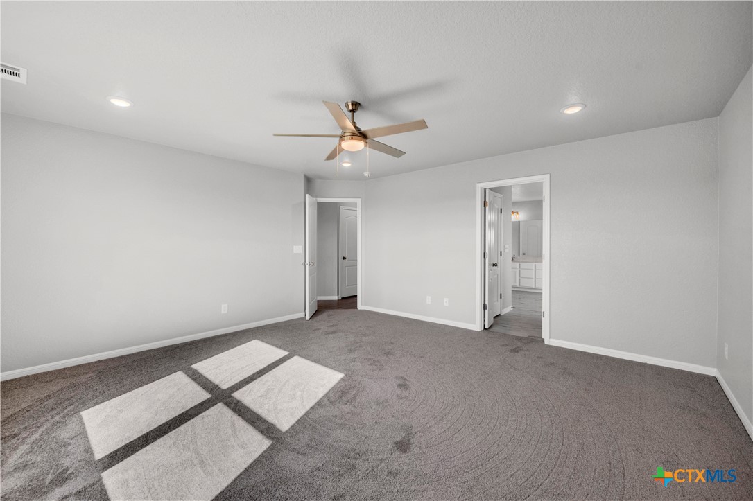 215 Overlook Trail Copperas Cove, TX 76522 - Photo 21 of 36 an empty room with windows and fan