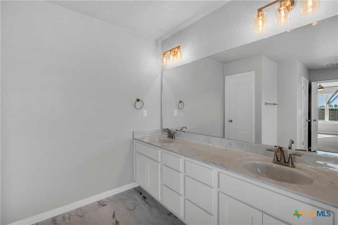 215 Overlook Trail Copperas Cove, TX 76522 - Photo 22 of 36 a bathroom with a granite countertop sink and a mirror
