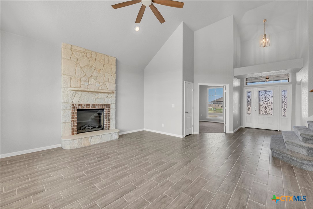 215 Overlook Trail Copperas Cove, TX 76522 - Photo 8 of 36 an empty room with wooden floor fireplace and windows