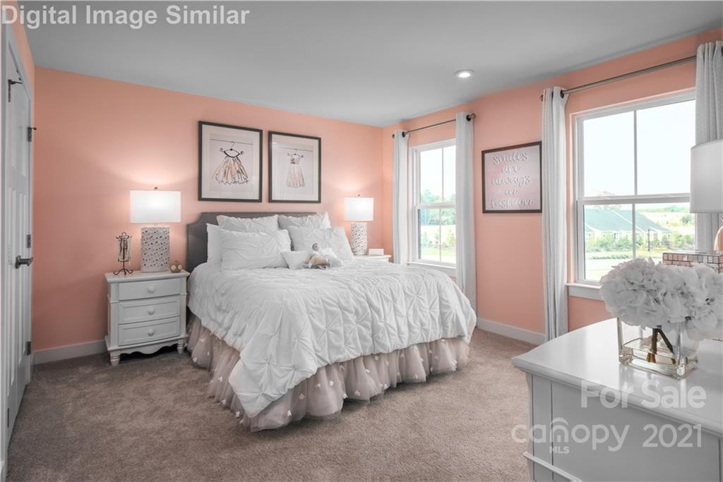 7230 Waterwheel Street Southwest, Unit 100 Concord, NC 28025 - Photo 11 of 23 a spacious bedroom with a bed and glass window