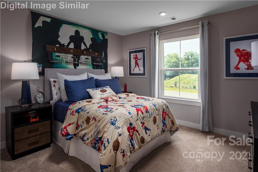 7230 Waterwheel Street Southwest, Unit 100 Concord, NC 28025 - Photo 12 of 23 a bedroom with a bed and window
