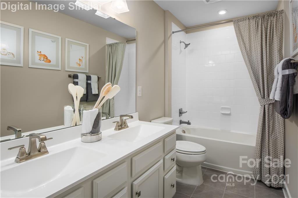 7230 Waterwheel Street Southwest, Unit 100 Concord, NC 28025 - Photo 14 of 23 a bathroom with a granite countertop sink toilet and shower