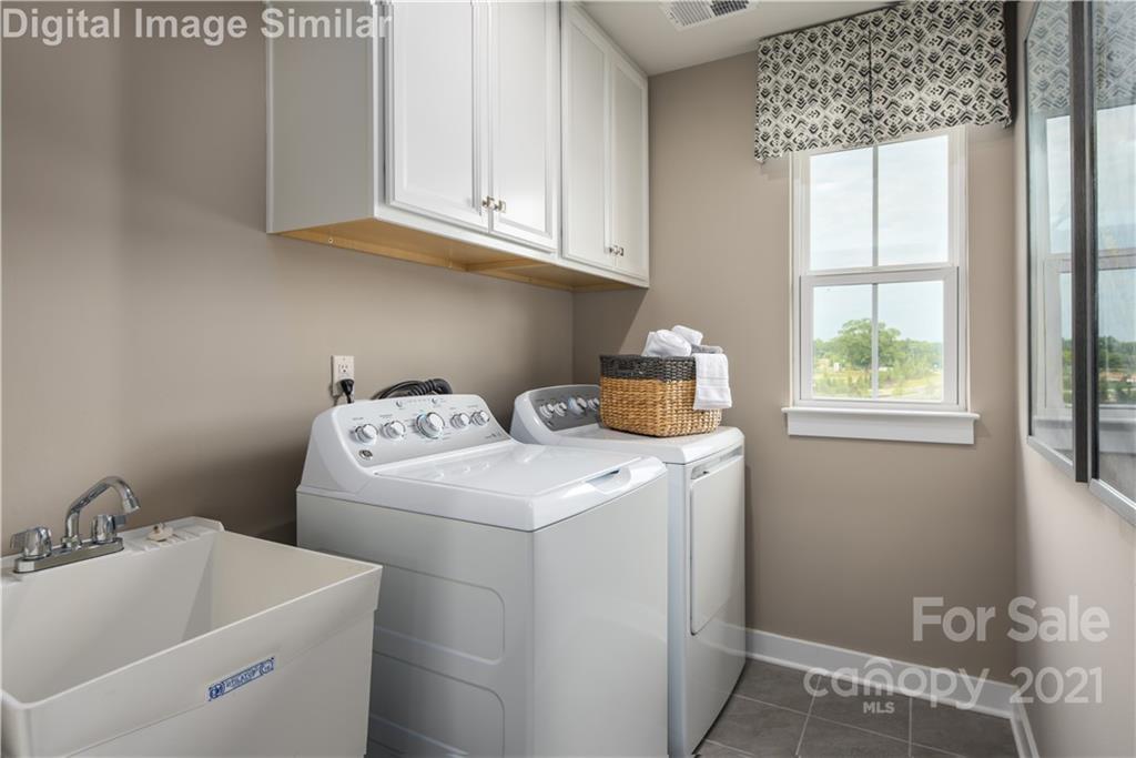 7230 Waterwheel Street Southwest, Unit 100 Concord, NC 28025 - Photo 15 of 23 a utility room with dryer and washer