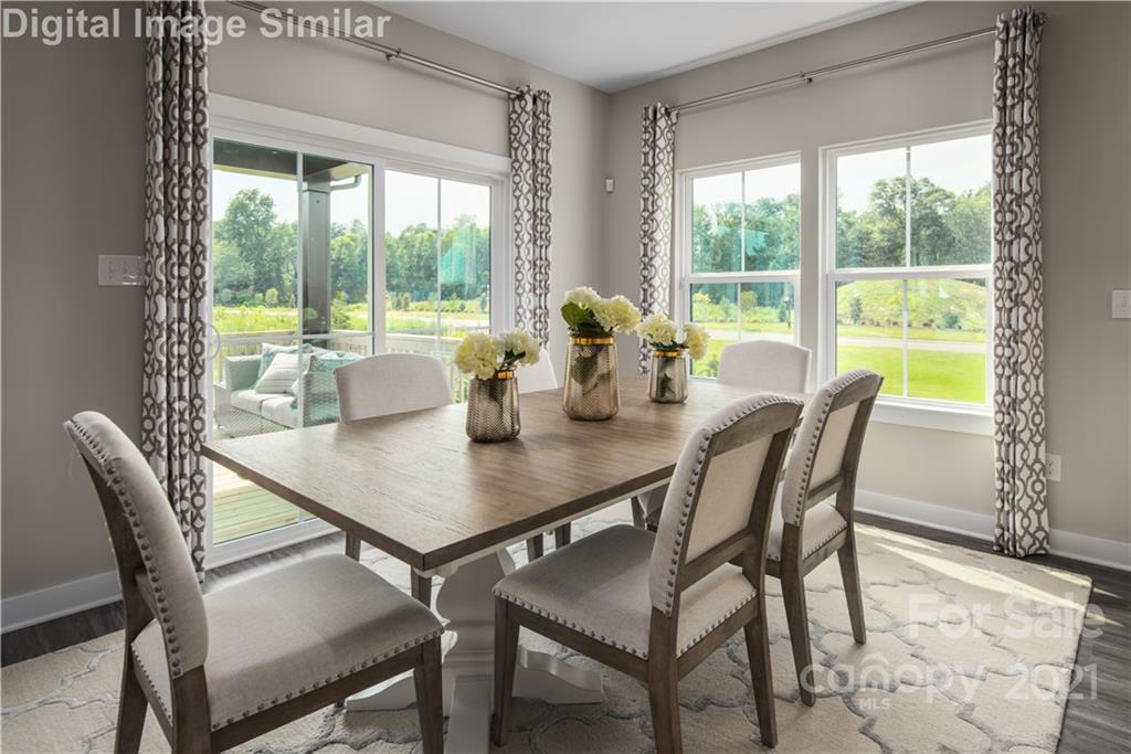 7230 Waterwheel Street Southwest, Unit 100 Concord, NC 28025 - Photo 7 of 23 a view of a dining room with furniture window and outside view