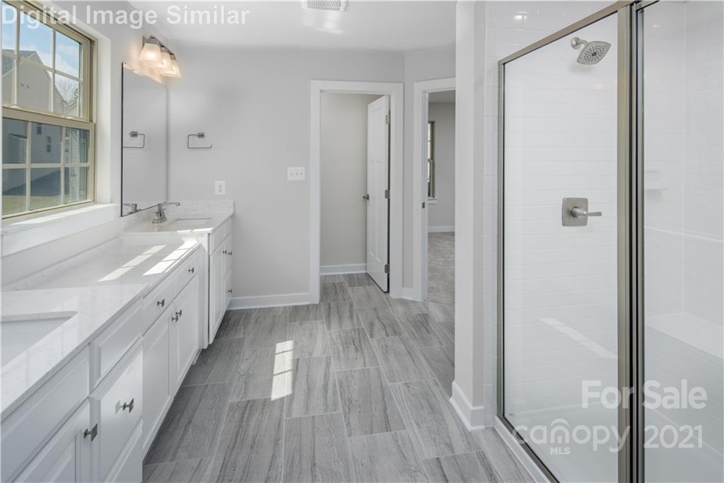 7230 Waterwheel Street Southwest, Unit 100 Concord, NC 28025 - Photo 10 of 23 a bathroom with a double vanity sink and a mirror