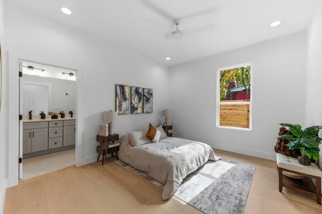 a bedroom with a bed and a potted plant
