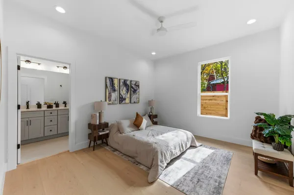 a bedroom with a bed and a potted plant