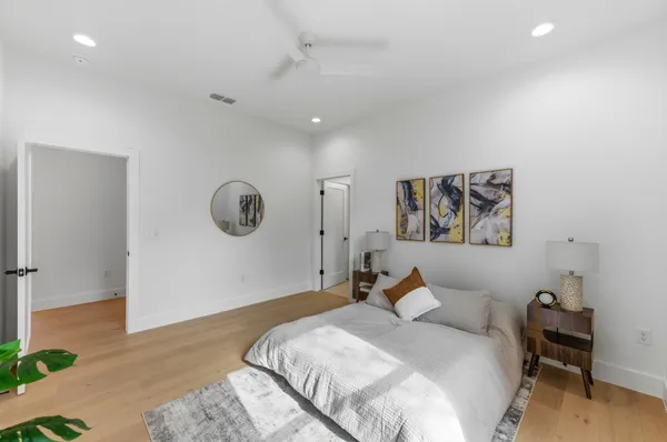 a bed room with a bed and a painting on the wall