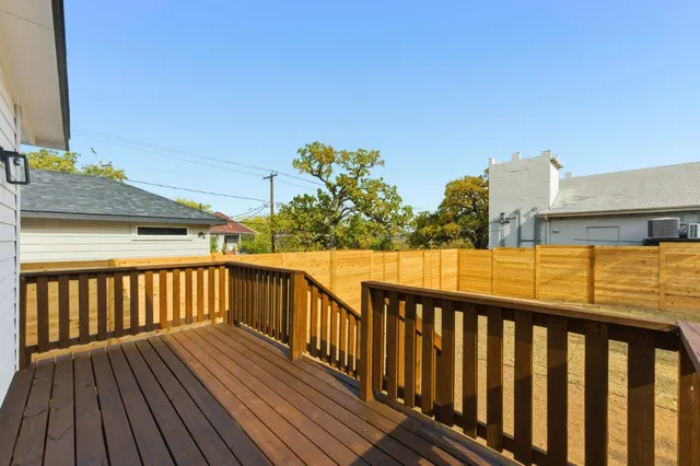 a view of a balcony with wooden floor