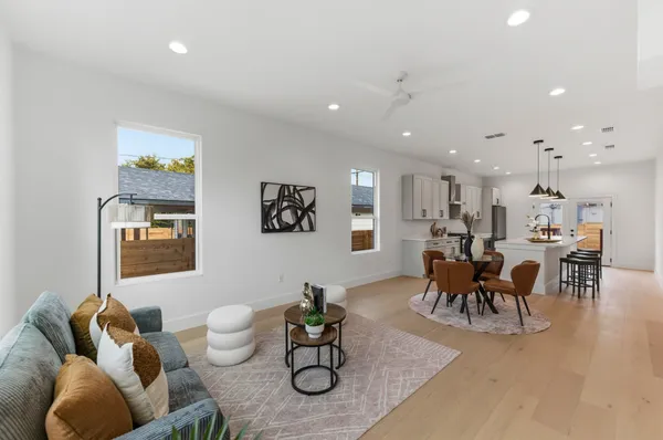a living room with furniture and wooden floor
