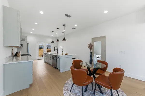 a living room with furniture a dining table and kitchen view