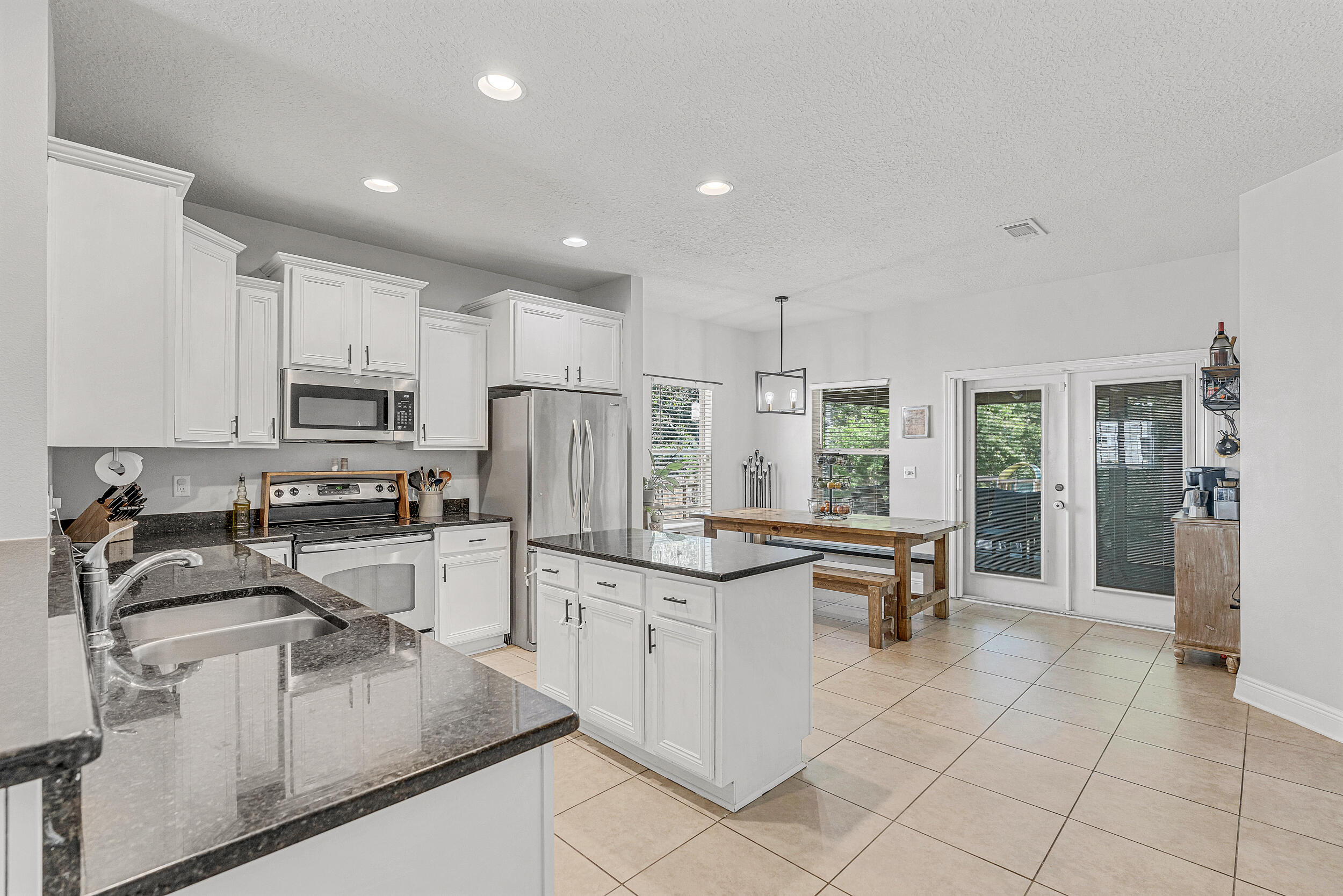 64 Rearden Way Santa Rosa Beach, FL 32459 - Photo 11 of 44 a kitchen with stainless steel appliances granite countertop a refrigerator and a stove top oven