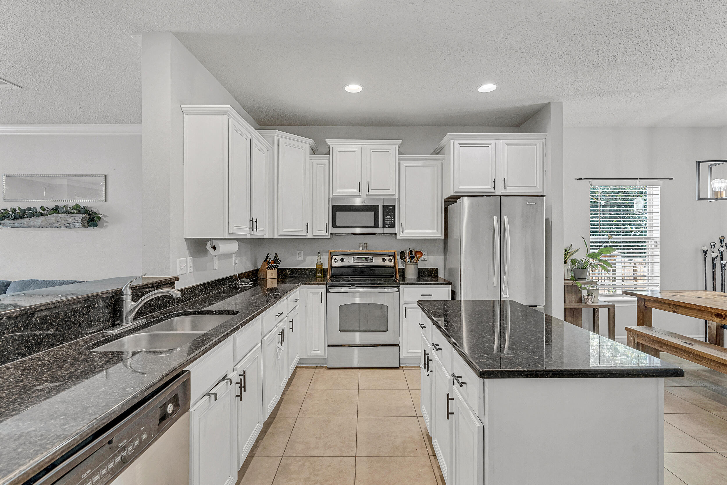 64 Rearden Way Santa Rosa Beach, FL 32459 - Photo 12 of 44 a kitchen with granite countertop a sink stove and refrigerator