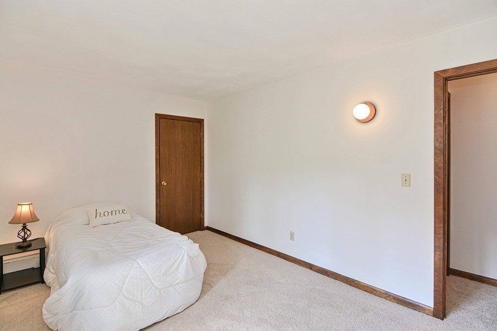 22 Wildwood Road Stow, MA 01775 - Photo 23 of 35 a bedroom with a bed and a night stand