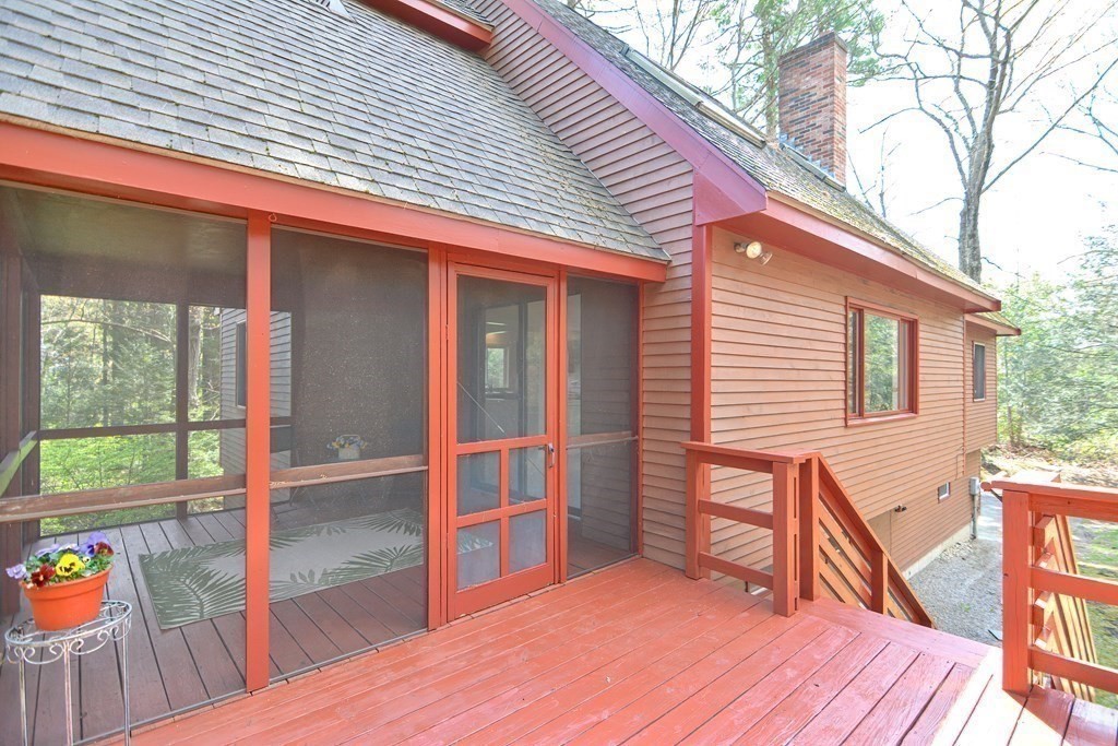 22 Wildwood Road Stow, MA 01775 - Photo 3 of 35 a backyard of a house with wooden floor and outdoor seating