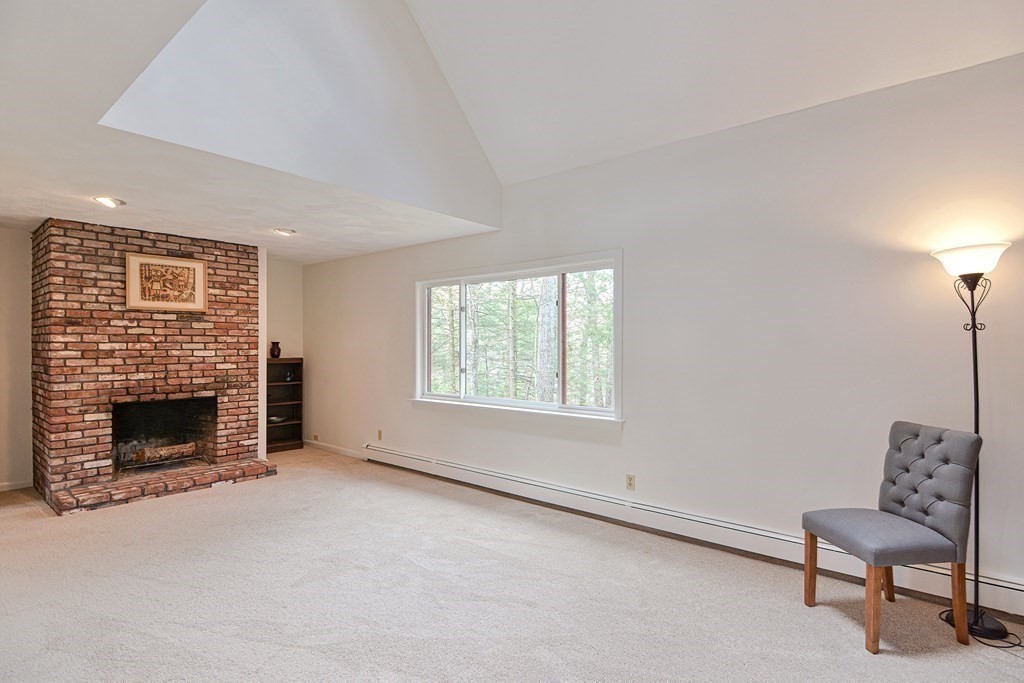 22 Wildwood Road Stow, MA 01775 - Photo 7 of 35 a living room with furniture and a fireplace
