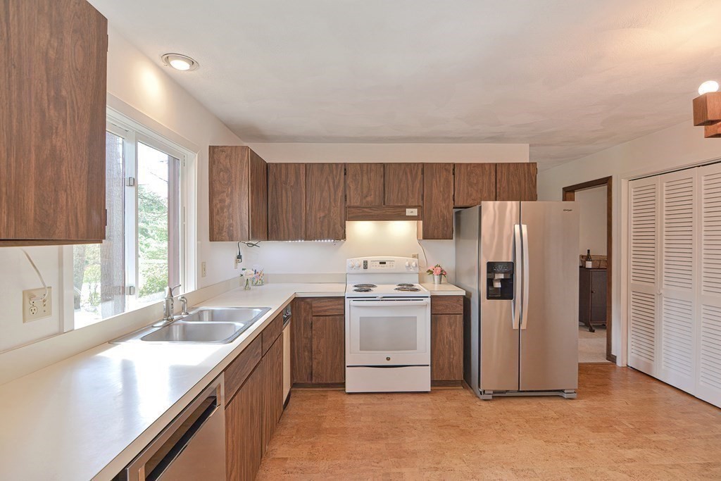 22 Wildwood Road Stow, MA 01775 - Photo 9 of 35 a kitchen with stainless steel appliances granite countertop a sink stove and refrigerator