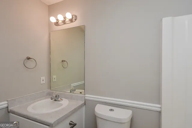 a bathroom with a sink vanity and toilet