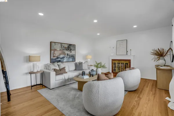 a living room with furniture a lamp and a potted plant