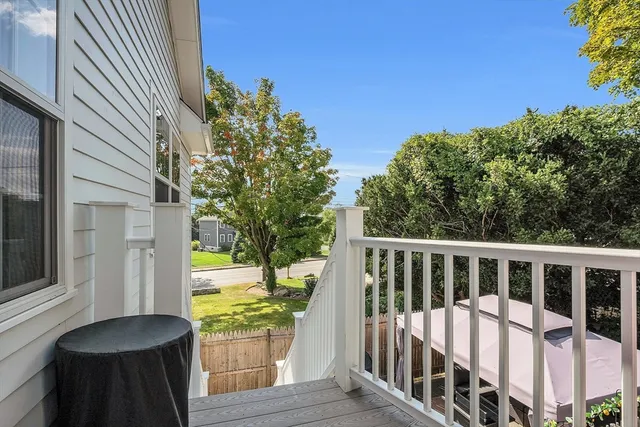 a view of balcony with wooden floor and fence