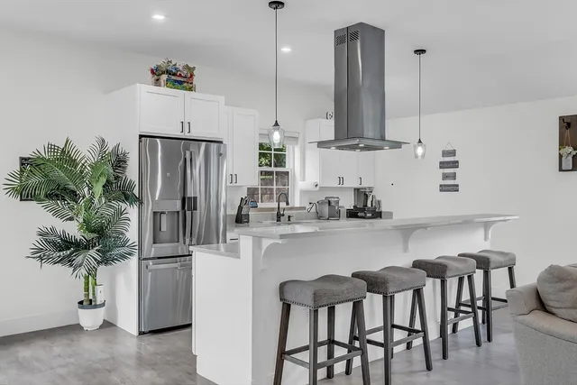 a kitchen with refrigerator and cabinets