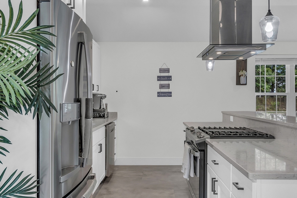 2253 Washington Street, Unit 2 Canton, MA 02021 - Photo 8 of 39 a kitchen with stainless steel appliances granite countertop a refrigerator a stove and a sink