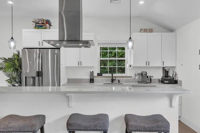 a kitchen with a sink cabinets and window