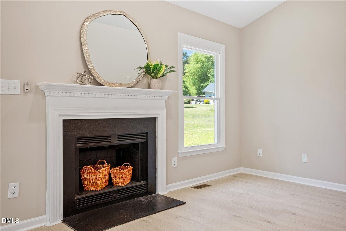 31 Fieldview Court Angier, NC 27501 - Photo 3 of 25 a living room with a fireplace a stove and a window