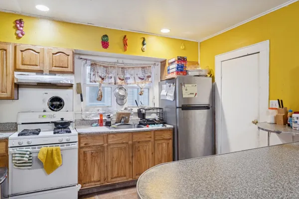a kitchen with stainless steel appliances a sink stove and refrigerator