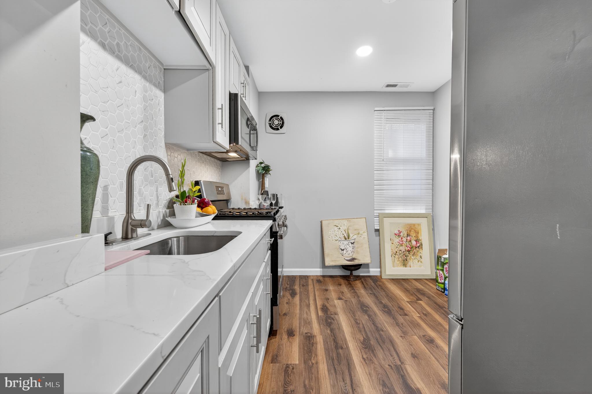 1206 11th Street Northwest Washington, DC 20005 - Photo 1 of 44 a kitchen with a sink a stove and cabinets