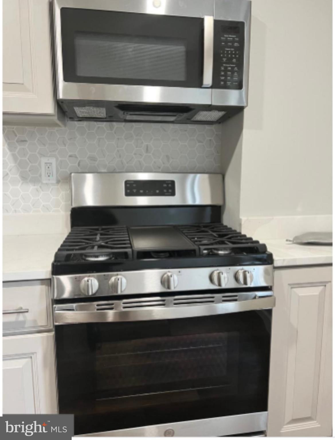 1206 11th Street Northwest Washington, DC 20005 - Photo 14 of 44 a stove top oven sitting inside of a kitchen
