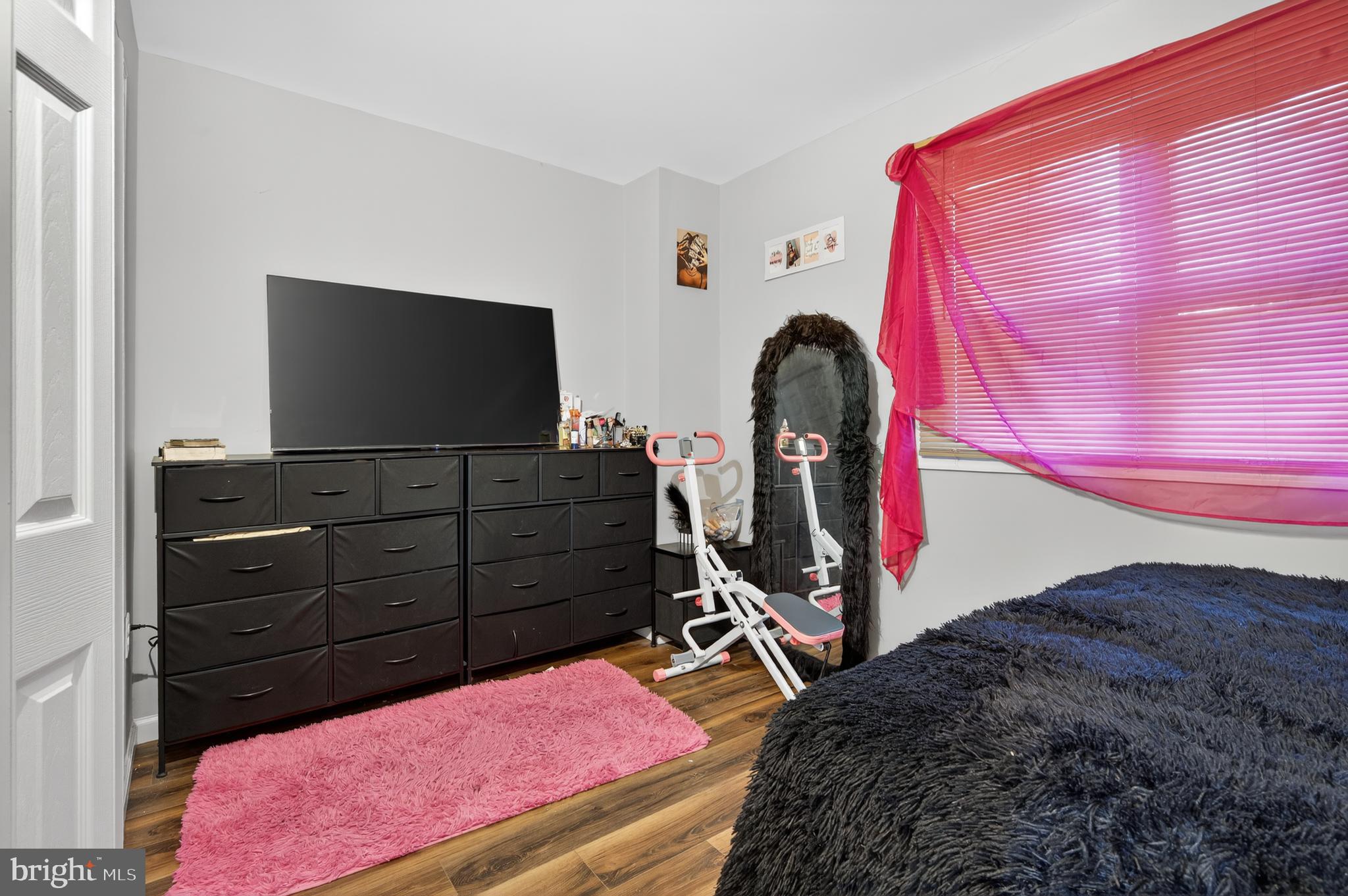 1206 11th Street Northwest Washington, DC 20005 - Photo 3 of 44 a bedroom with a bed and a flat screen tv