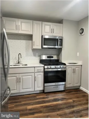 a kitchen with granite countertop a stove and a sink