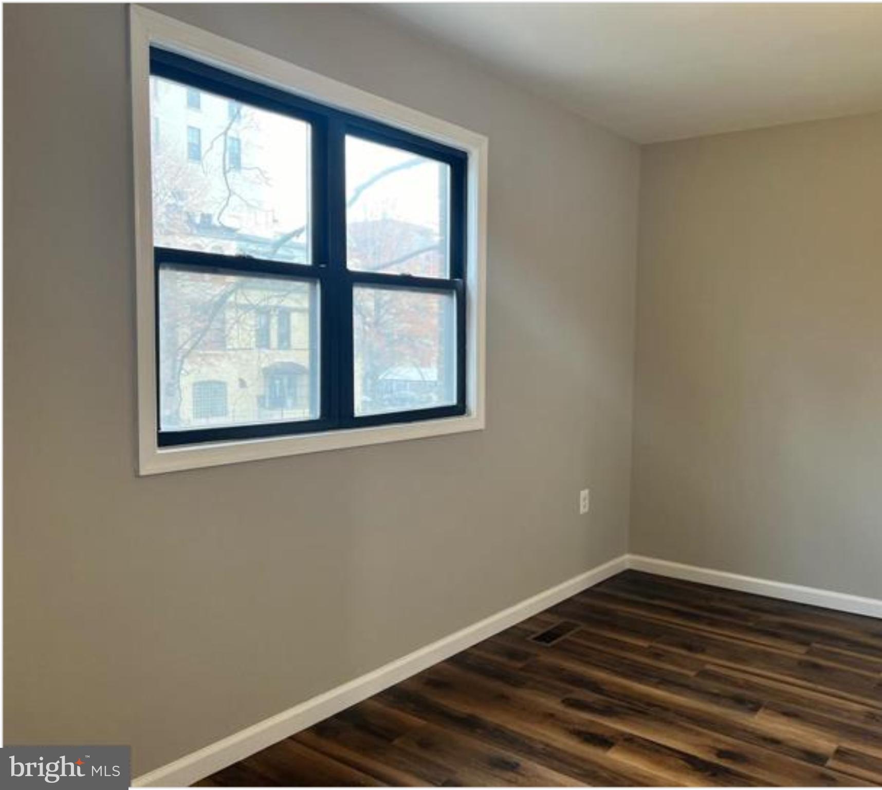 1206 11th Street Northwest Washington, DC 20005 - Photo 34 of 44 a view of an empty room with wooden floor and a window