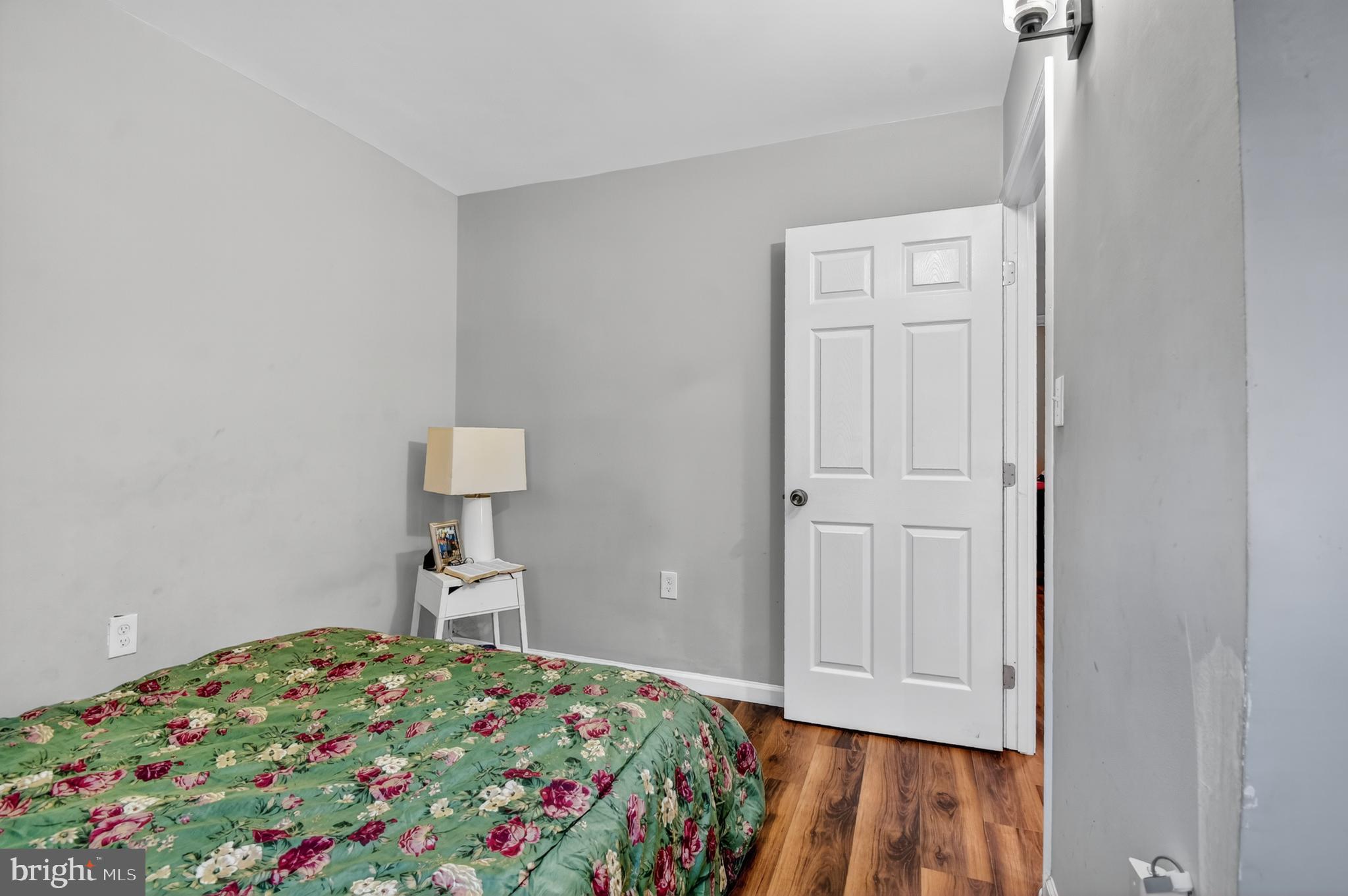 1206 11th Street Northwest Washington, DC 20005 - Photo 41 of 44 a bedroom with a bed and a lamp on dresser