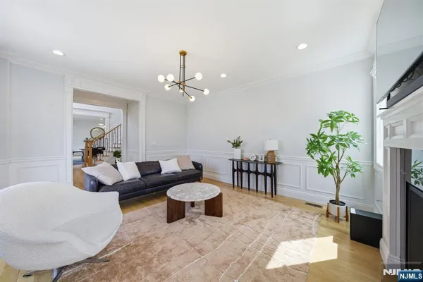 a living room with furniture and a chandelier