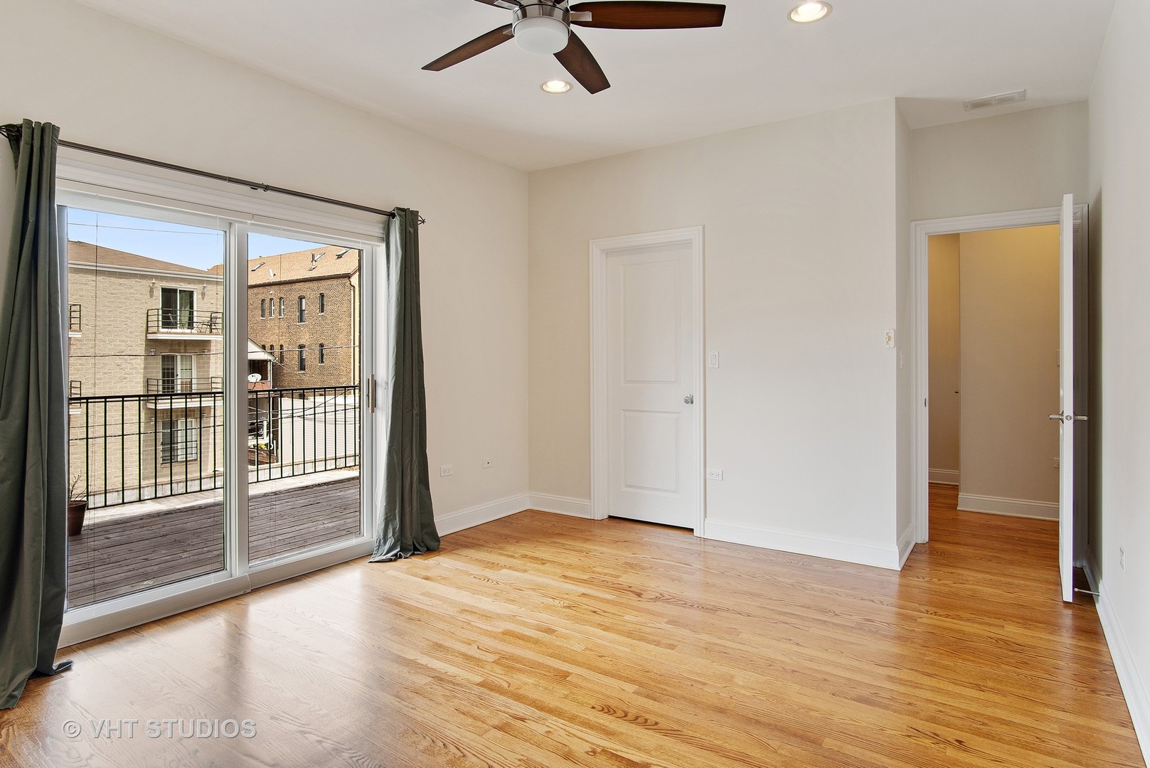 1502 West Augusta Boulevard, Unit 3W Chicago, IL 60642 - Photo 13 of 23 an empty room with wooden floor and windows