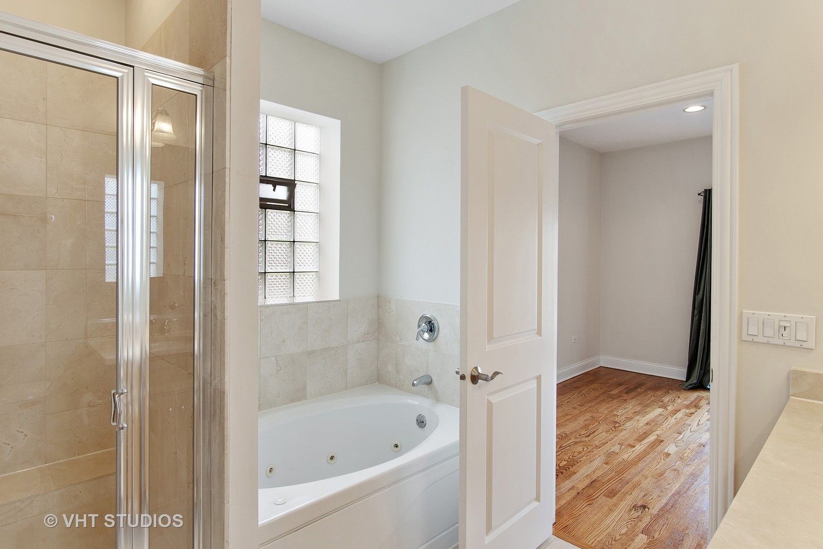 1502 West Augusta Boulevard, Unit 3W Chicago, IL 60642 - Photo 15 of 23 a bathroom with a bathtub and a shower
