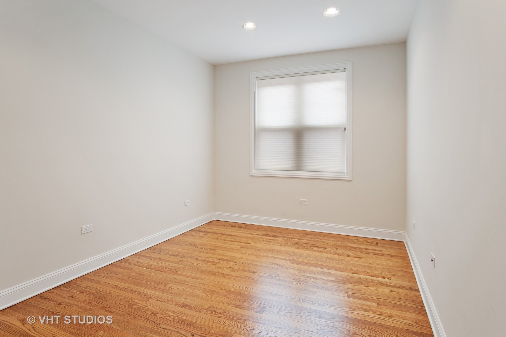 1502 West Augusta Boulevard, Unit 3W Chicago, IL 60642 - Photo 16 of 23 an empty room with wooden floor and windows