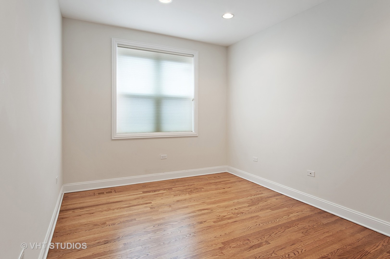 1502 West Augusta Boulevard, Unit 3W Chicago, IL 60642 - Photo 18 of 23 an empty room with wooden floor and a window