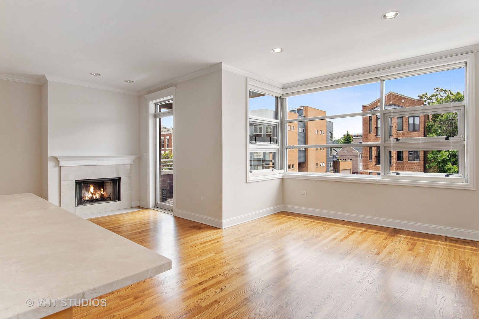 1502 West Augusta Boulevard, Unit 3W Chicago, IL 60642 - Photo 3 of 23 a living room with furniture and a fireplace