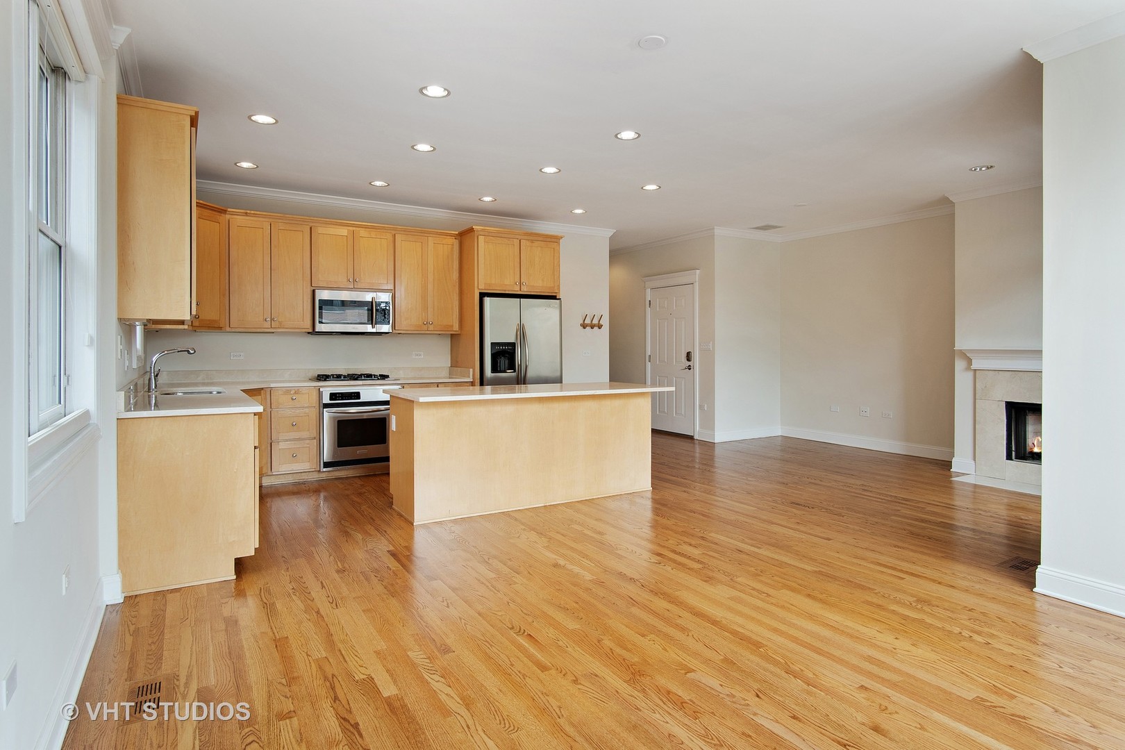 1502 West Augusta Boulevard, Unit 3W Chicago, IL 60642 - Photo 5 of 23 a large kitchen with cabinets and wooden floor