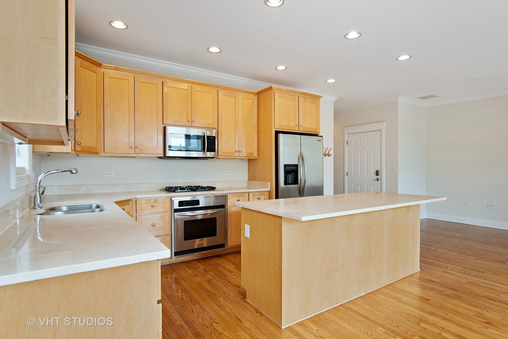 1502 West Augusta Boulevard, Unit 3W Chicago, IL 60642 - Photo 9 of 23 a kitchen with a stove a sink and a refrigerator