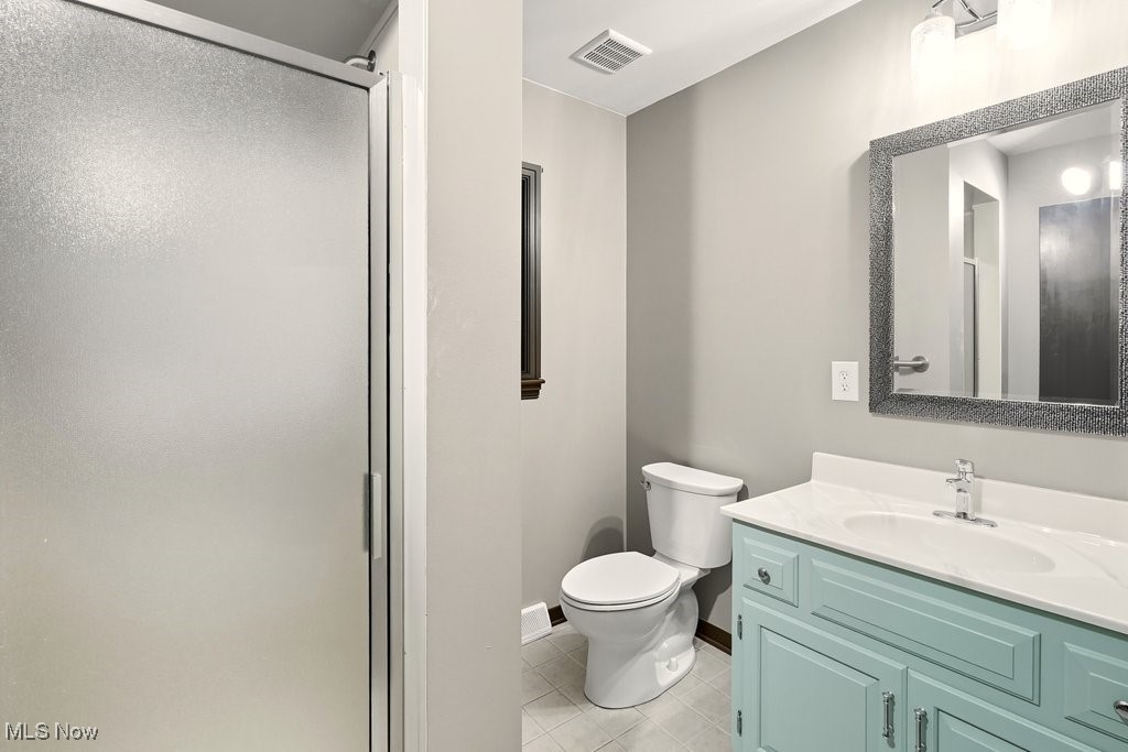635 Inverness Road Akron, OH 44313 - Photo 21 of 36 Full bath featuring vanity, light tile patterned flooring, and a shower stall