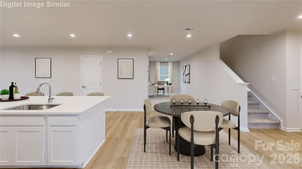 a kitchen that has a table and chairs in it
