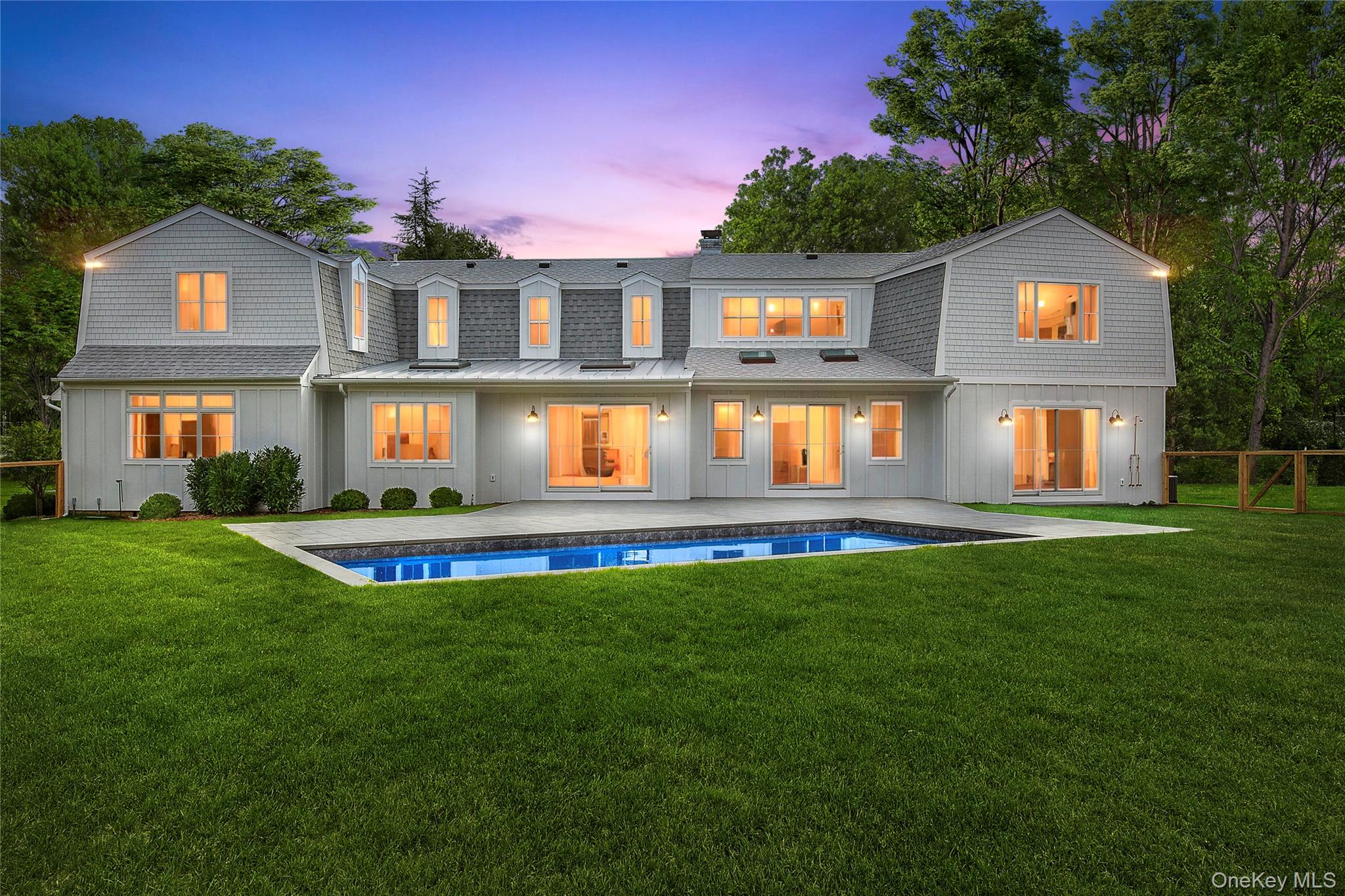 5 Pheasant Lane Remsenburg, NY 11960 - Photo 1 of 27 Back of property at dusk with a gambrel roof, a lawn, and a patio
